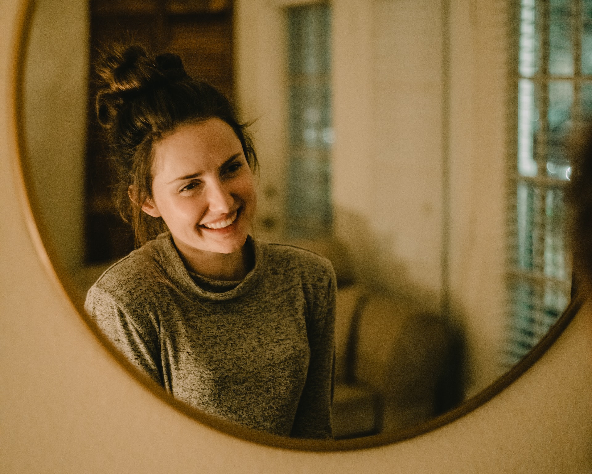 woman smiling in the mirror